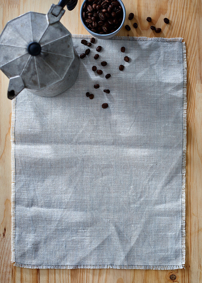 A mocha pot and coffee beans