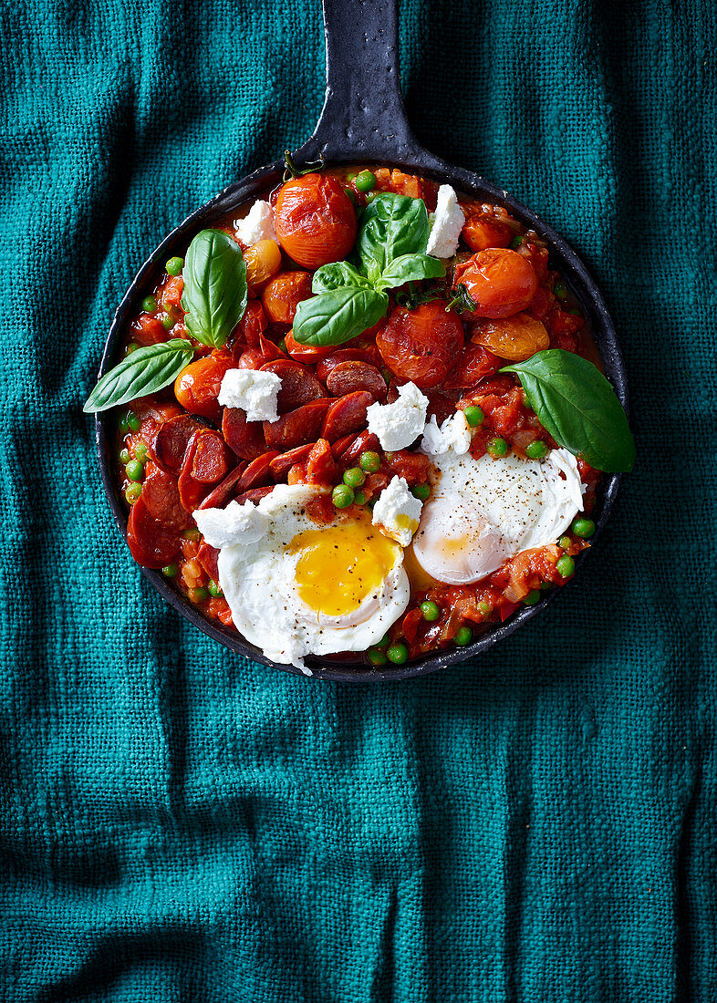 Mediterranean fried tomatoes and peas with chorizo and eggs
