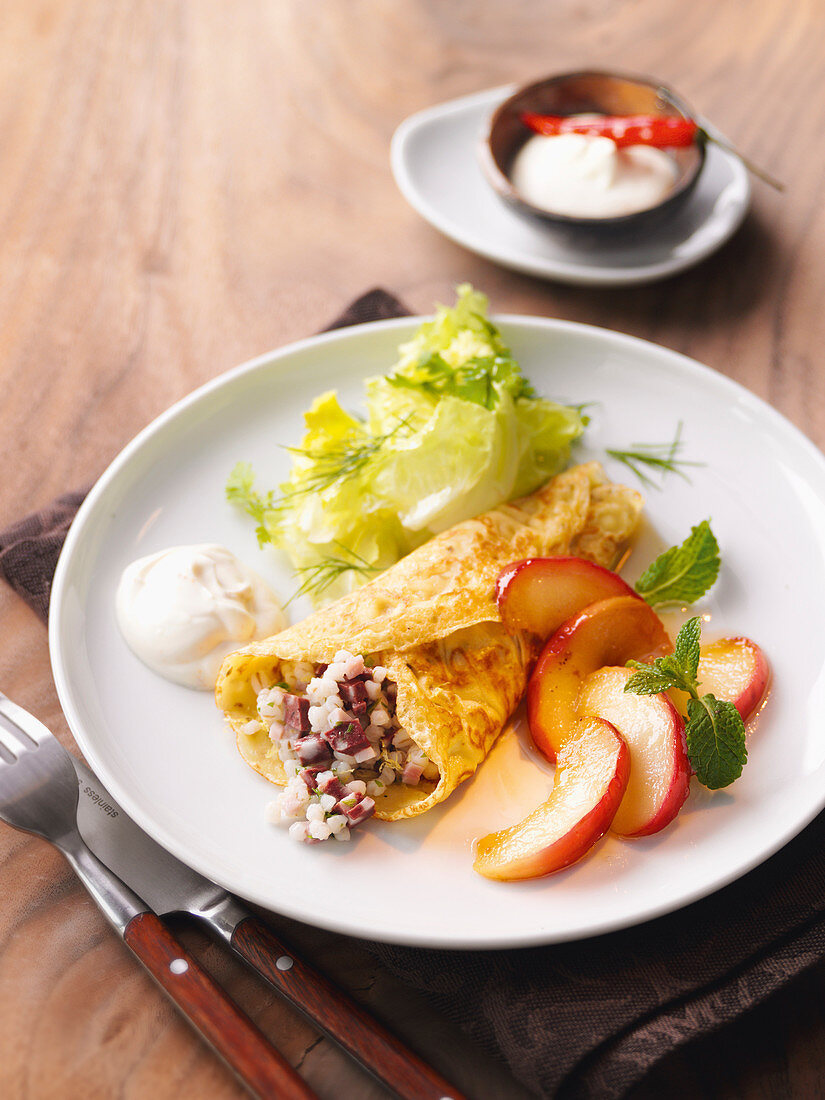 Stuffed marjoram crêpe with black pudding barley and apple wedges