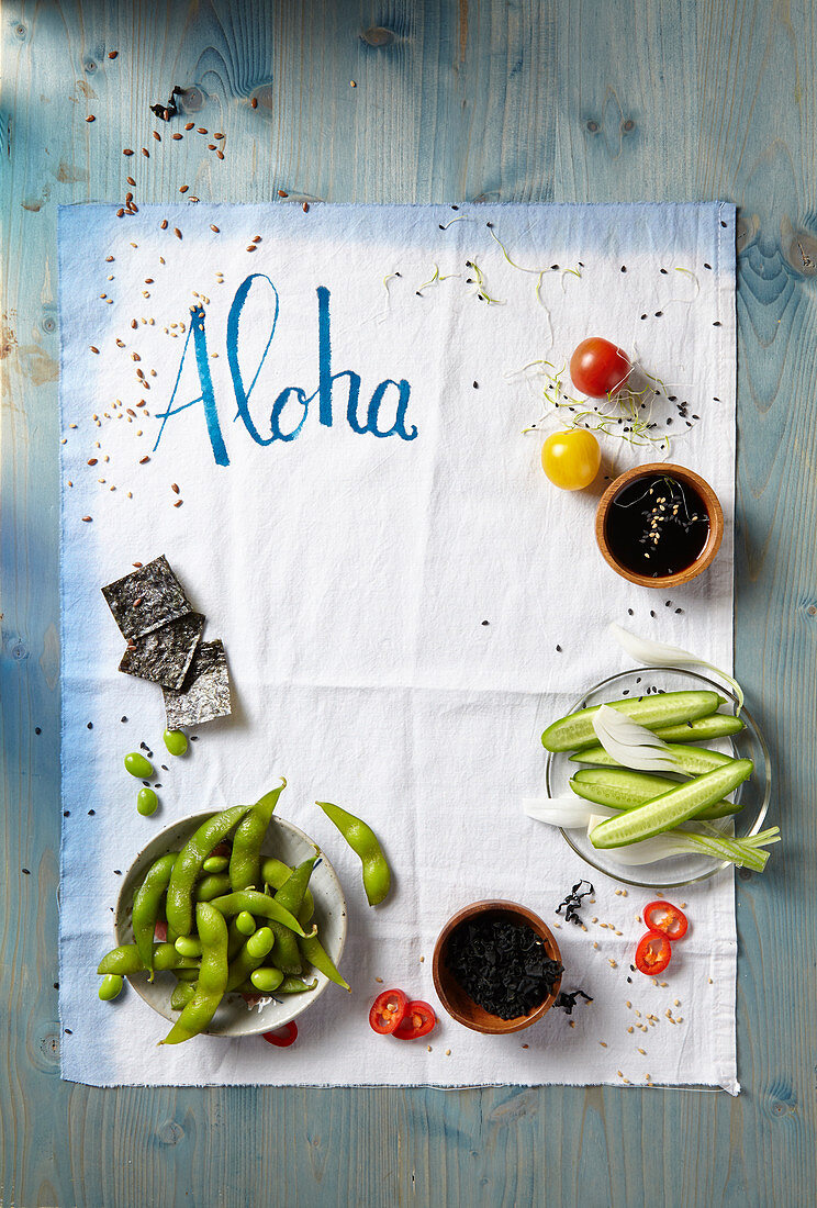 Various Asian ingredients, a tea towel with 'Aloha' written