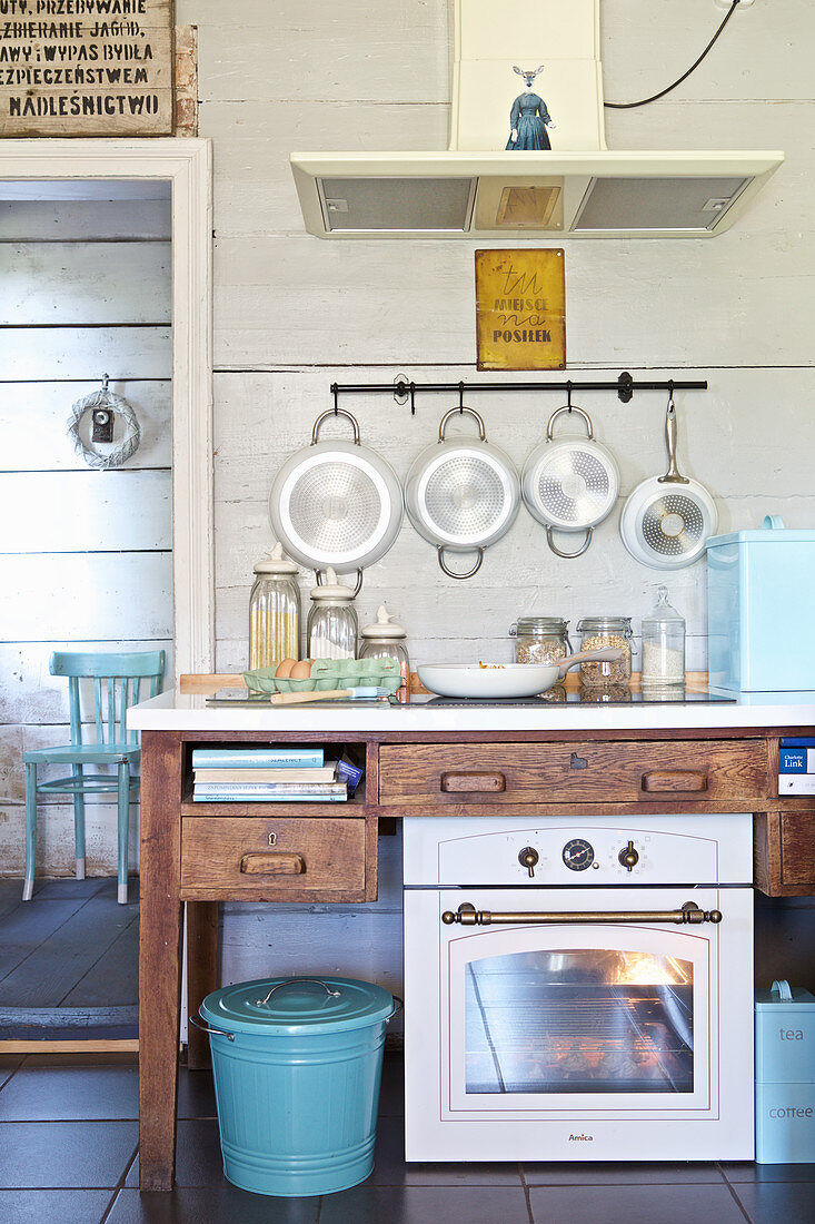 Oven, ceramic hob and extractor hood in country-house kitchen