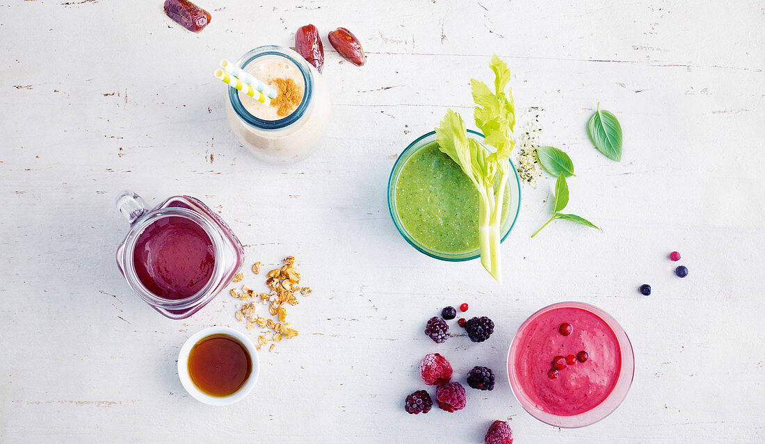Colourful smoothies made with bananas, berries and avocado