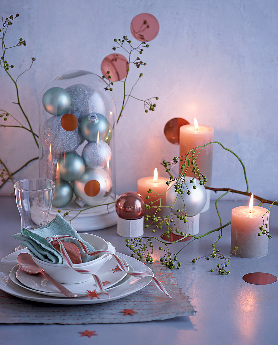 Place setting and Christmas arrangement with lit candles