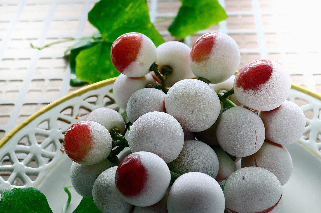 Frozen red grapes on a dish