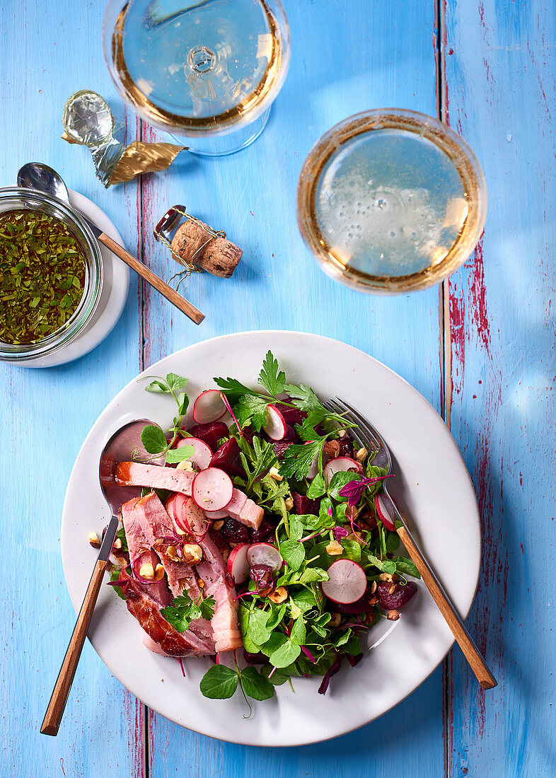 A herb salad with ham, beetroot, hazelnuts and dried cranberries