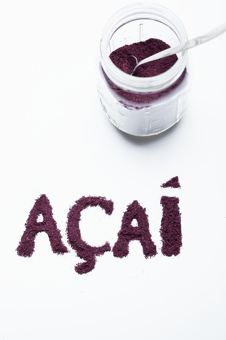 Acai berry powder: in a glass jar and lettered against a white background
