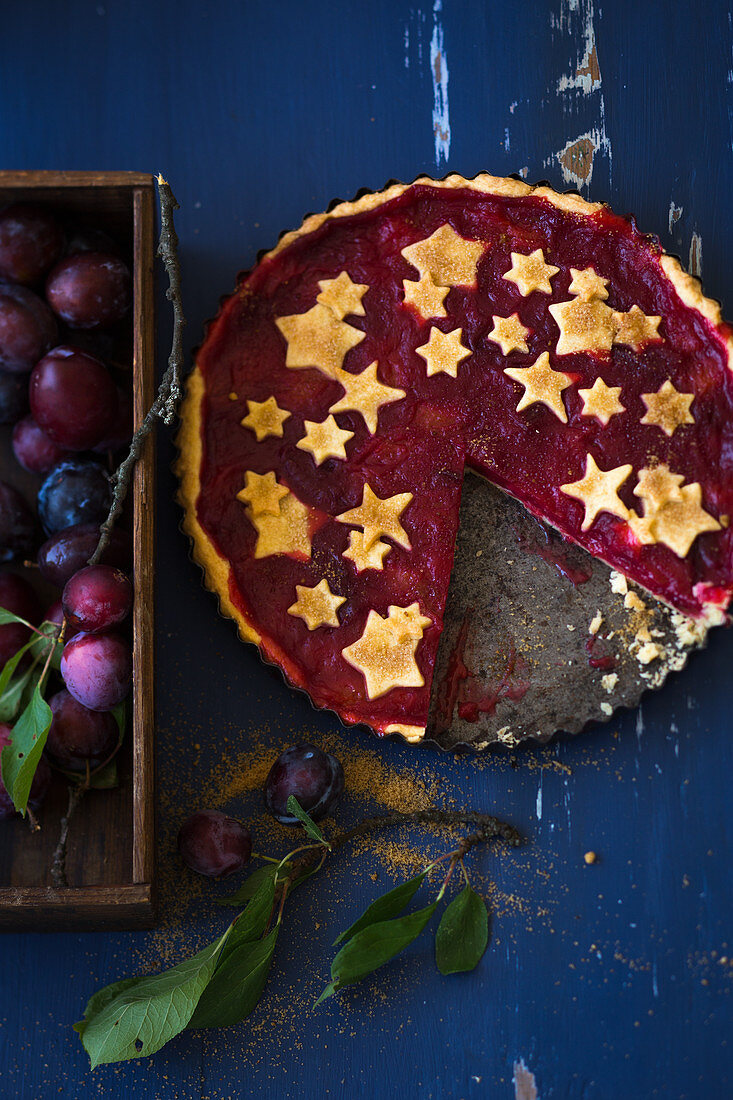 A plum tart decorated with pastry stars (Chrismas)