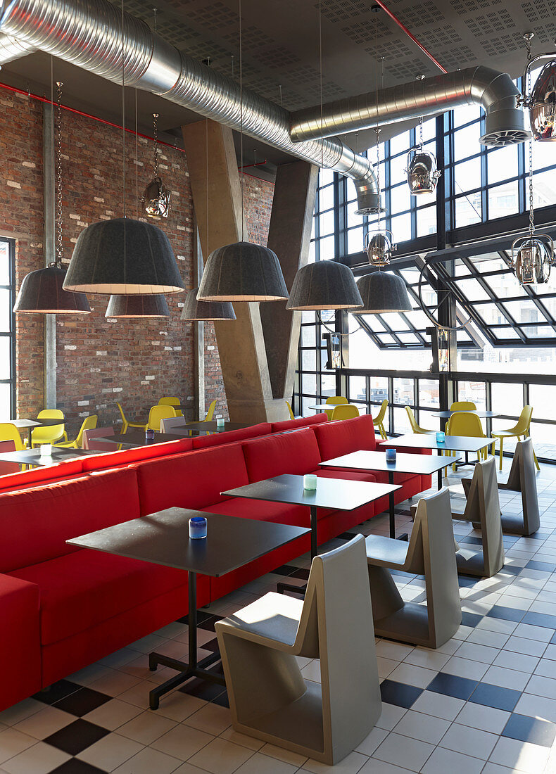 Red bench, grey tables and chairs in restaurant