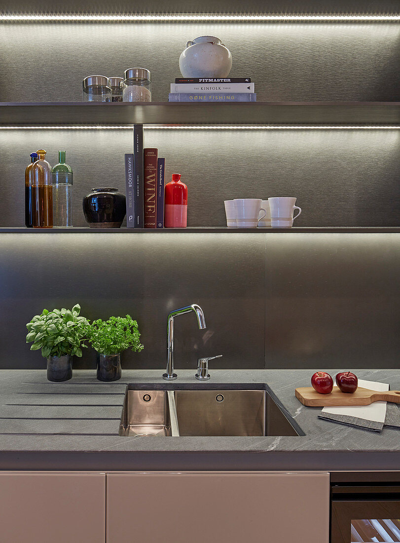 Open kitchen shelves with indirect lighting above sink