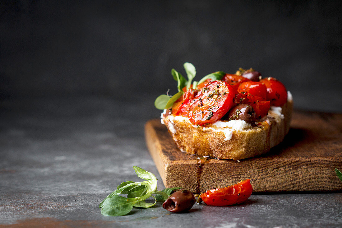 Tomato sourdough sandwich with ricotta and olives