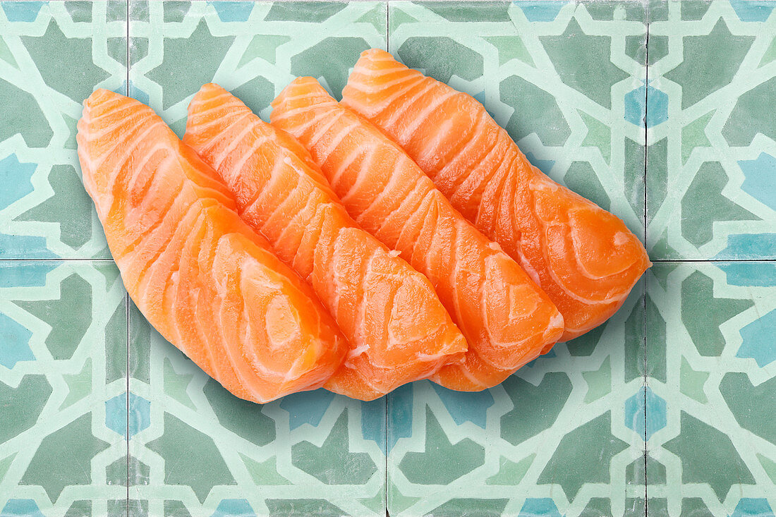 Four raw salmon steaks (seen from above)