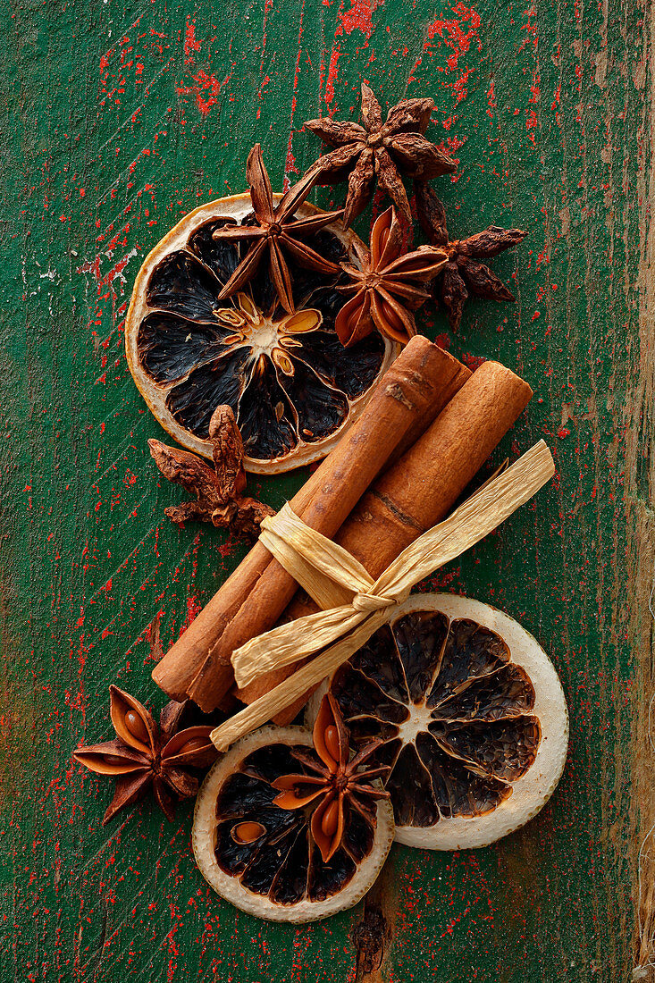 an arrangement of spices with star anise, cinnamon and dried orange slices