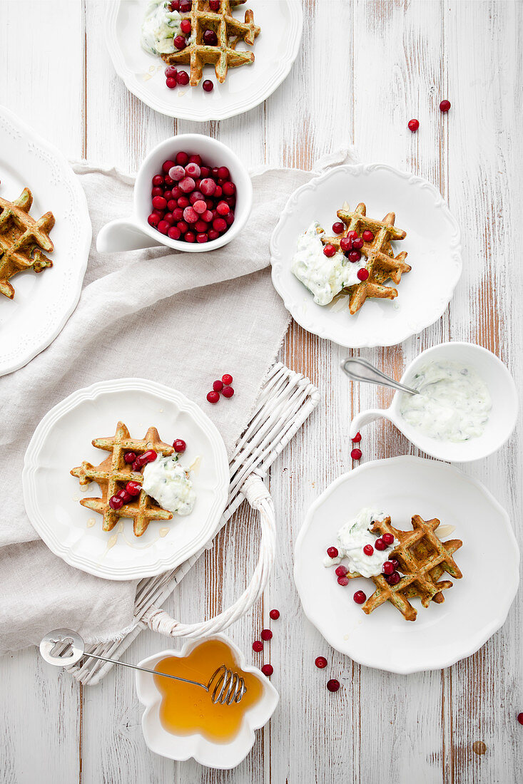 Spinach waffles with greek tzatziki, honey and lingonberries