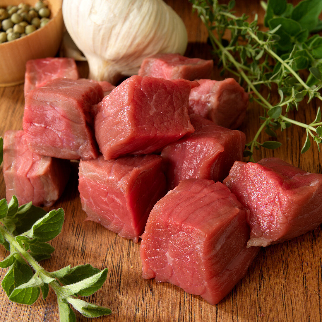 Raw beef cut into cubes with garlic and herbs