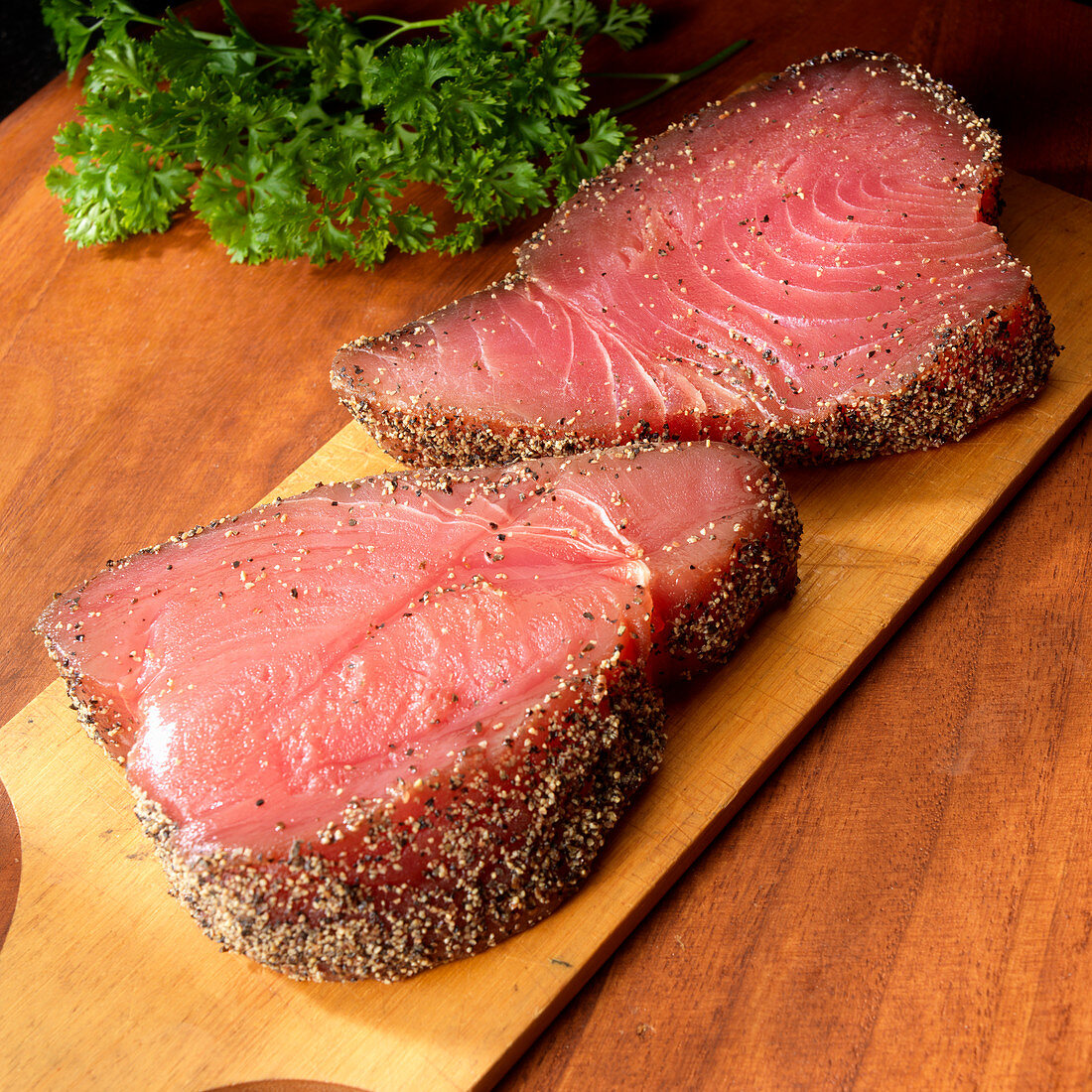 Two tuna steaks with black pepper coating