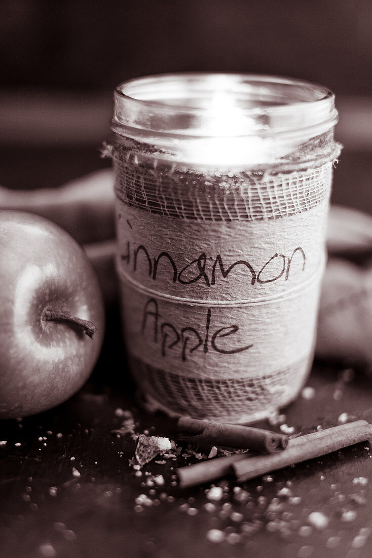 Cinnamon and apple scented candle in jar