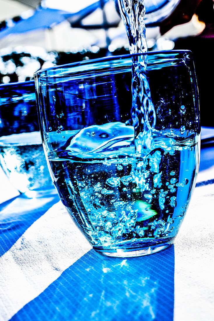 A water glass with a blue light effect