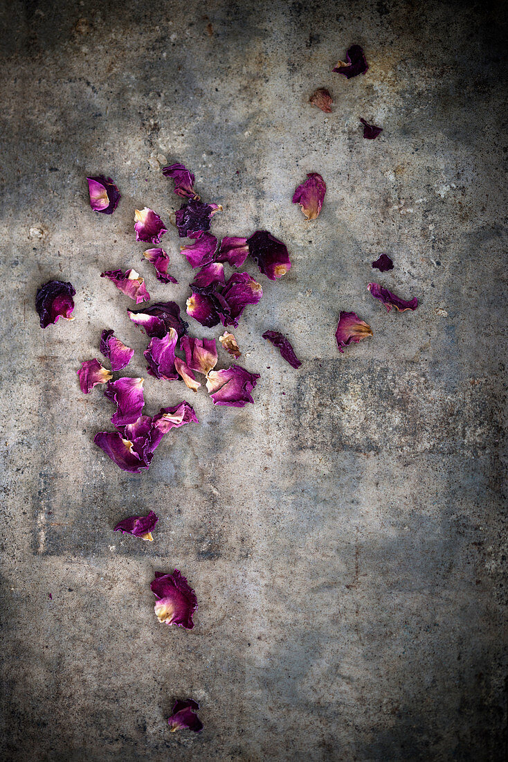 Dried rose petals on an antique surface