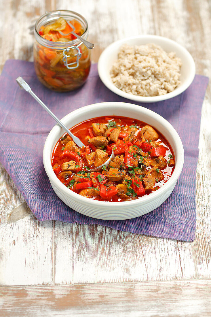 Pork goulash with peppers served with rice