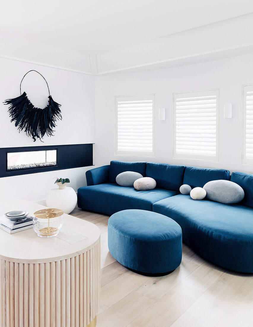 Blue sofa set with ottoman in bright living room