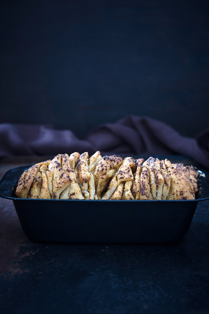 Vegan pull-apart bread with red pesto in a baking tin