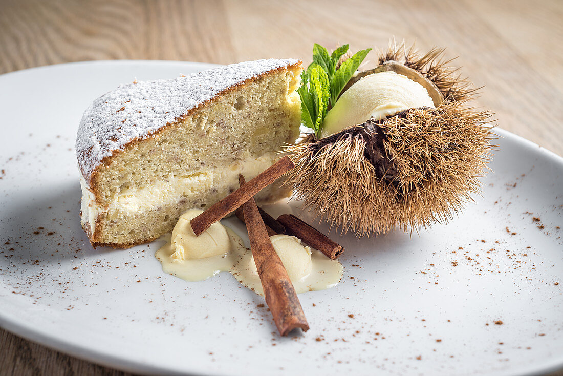 Chestnut cream sponge cake with cinnamon served with vanilla and chestnut ice cream garnished with fresh mint