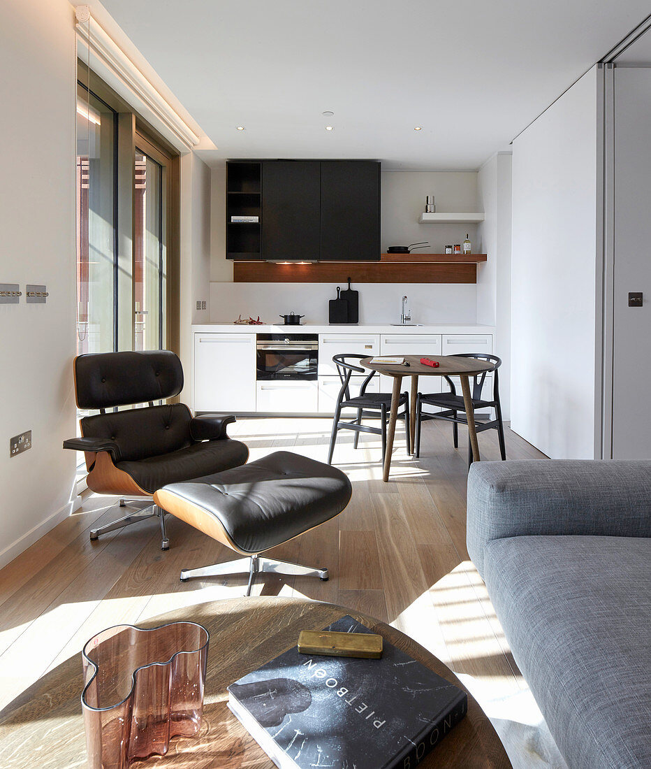 View from living room into open-plan kitchen with large TV