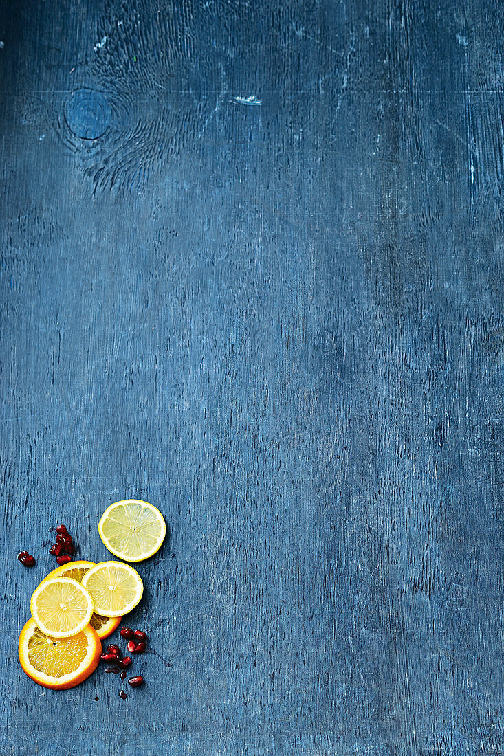 Orange, lemon, and lime slices on a blue background