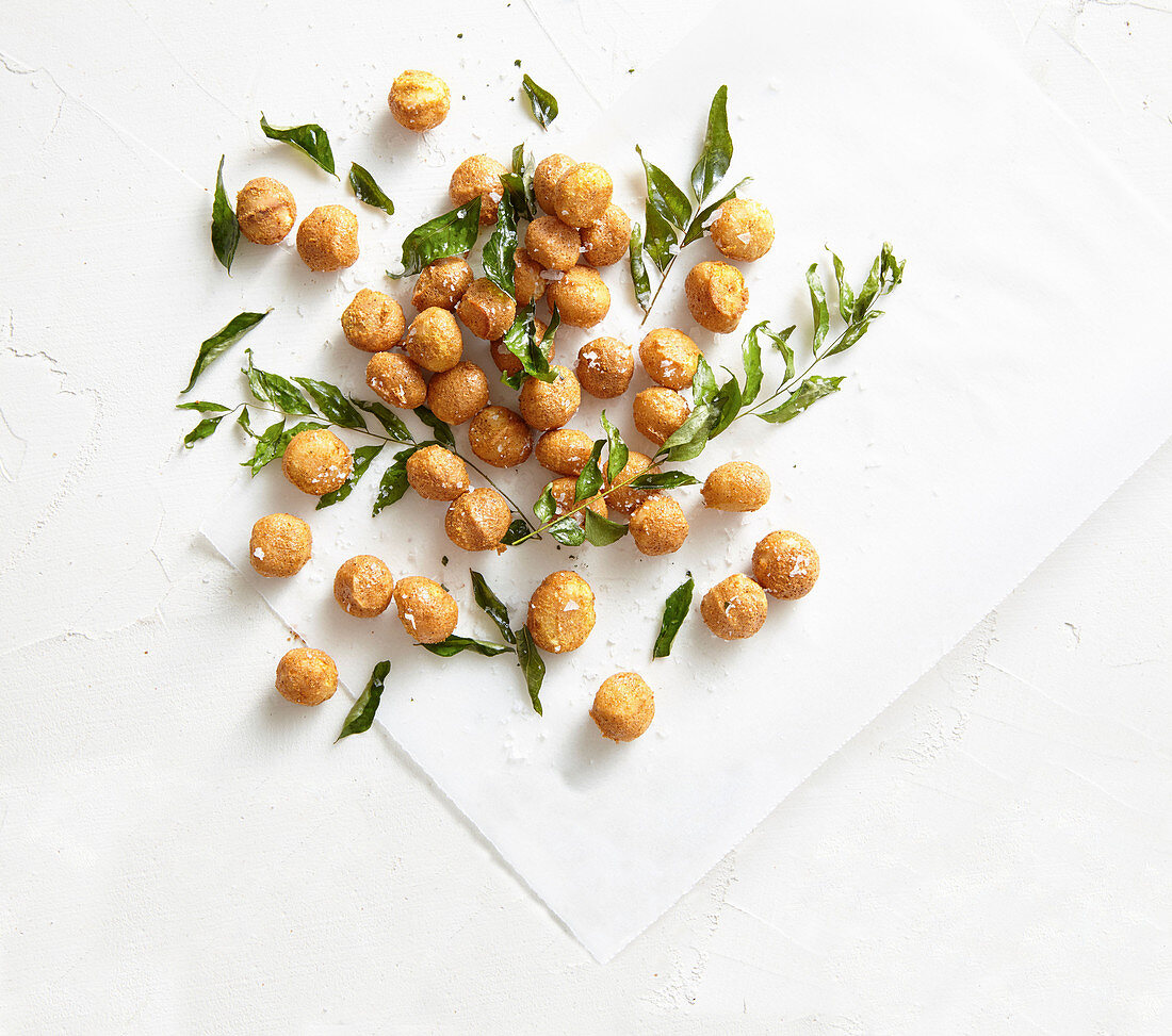 Macadamia nuts with curry powder, curry leaves and sea salt flakes