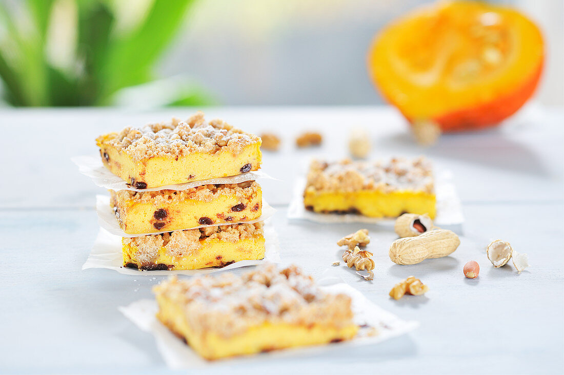 Pumpkin cheesecake bars with walnut and peanut streusel and chocolate drops (vegan)