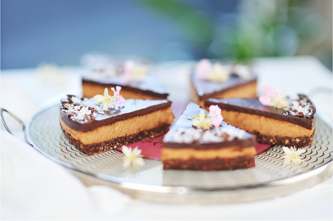 Raw chocolate cake slices with coconut date bases, sunflower seed cream and chocolate icing (vegan)