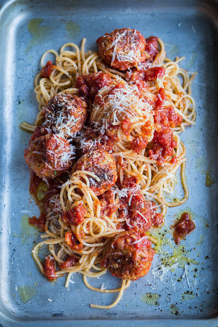 Spaghetti with meatballs on a baking sheet