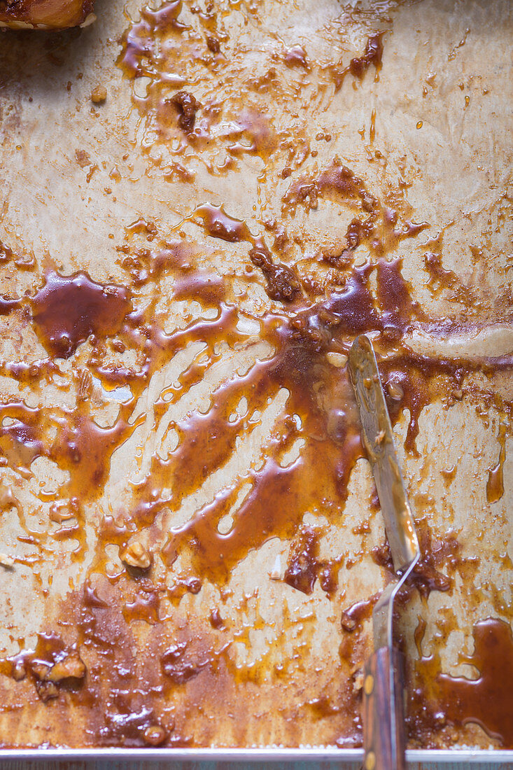 A baking tray with pastry and caramel sauce remains