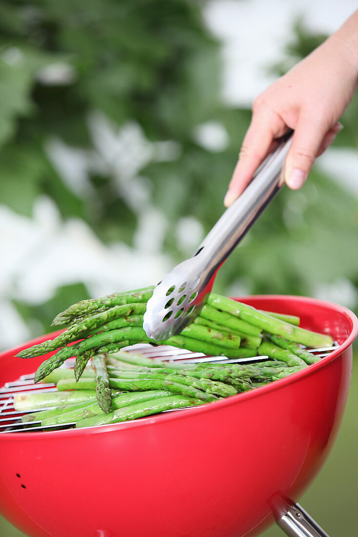 Green asparagus on a round barbecue