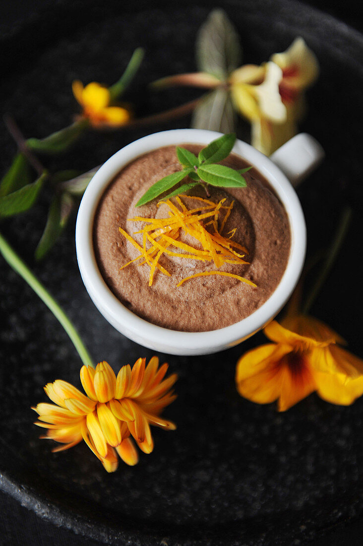 Chocolate terrine in a cup decorated with yellow flowers
