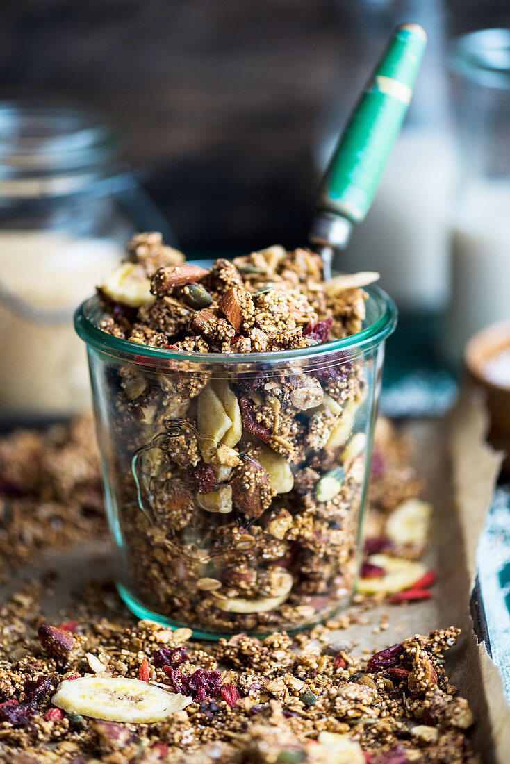 Amaranth and nutbutter granola with dried fruit in a jar (vegan)