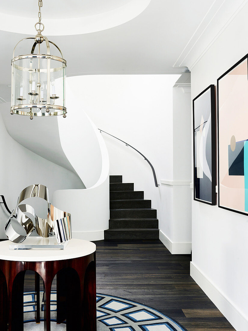 Side table with silver sculpture, stairs in the background