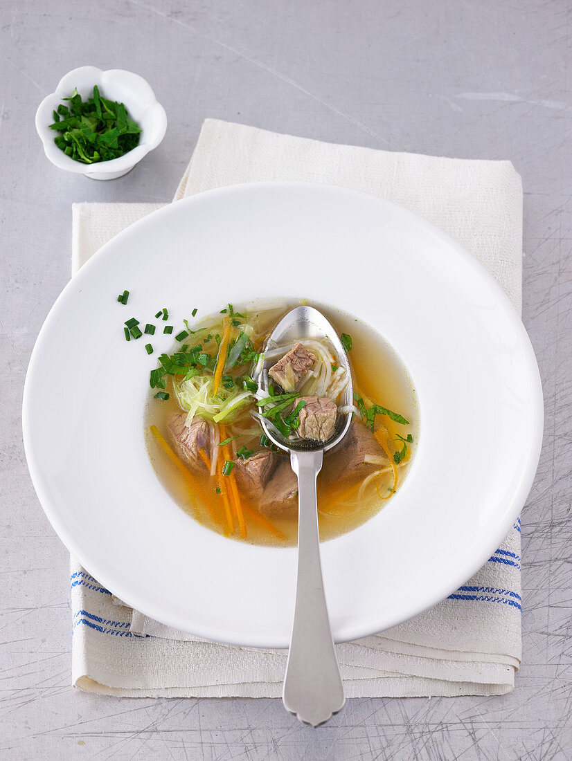 Beef broth with vegetables and herbs