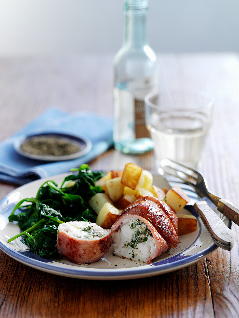 Monkfish wrapped in bacon with spinach and potatoes