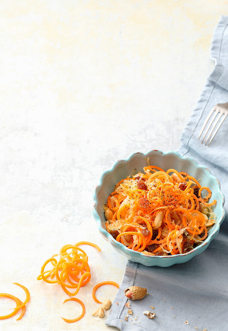 Raw carrot spaghetti with sauerkraut and peanuts