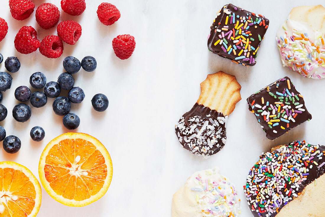 Healthy fresh fruits and unhealthy sweet pastries