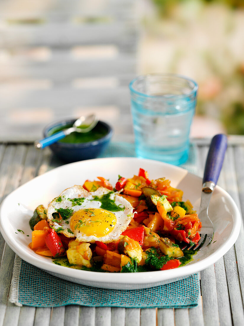 Vegetables with fried egg and Emerald sauce