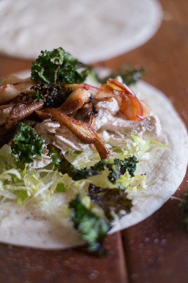 A wrap with chicken and kale
