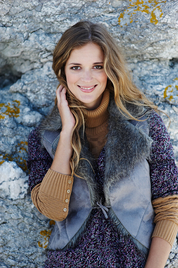 A long-haired woman wearing a fur gillet