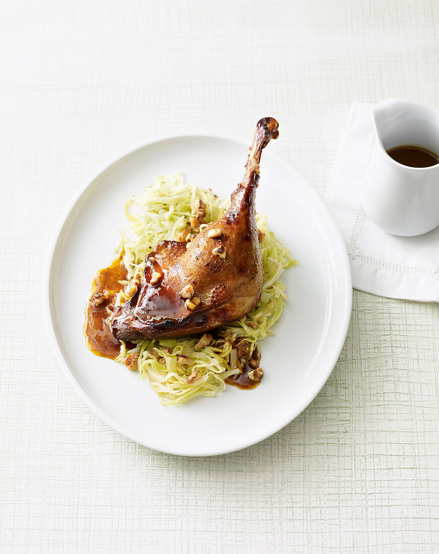 A beer-glazed goose leg on a bed of pointed cabbage