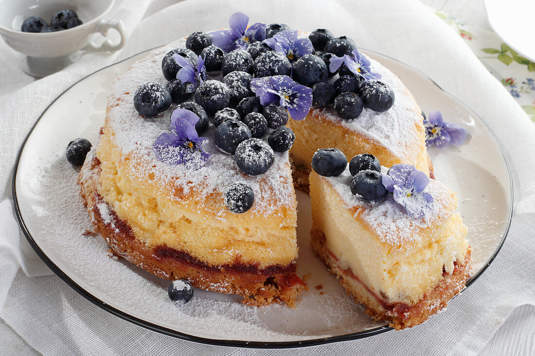 Cheesecake with blueberry and pansies