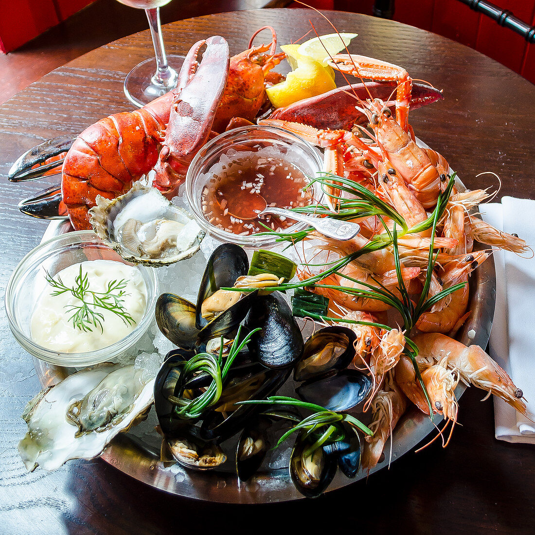 Fresh seafood platter with red lobster, langoustine, prawns, mussels, oysters, clams, with a tartare and sweet chilli sauce