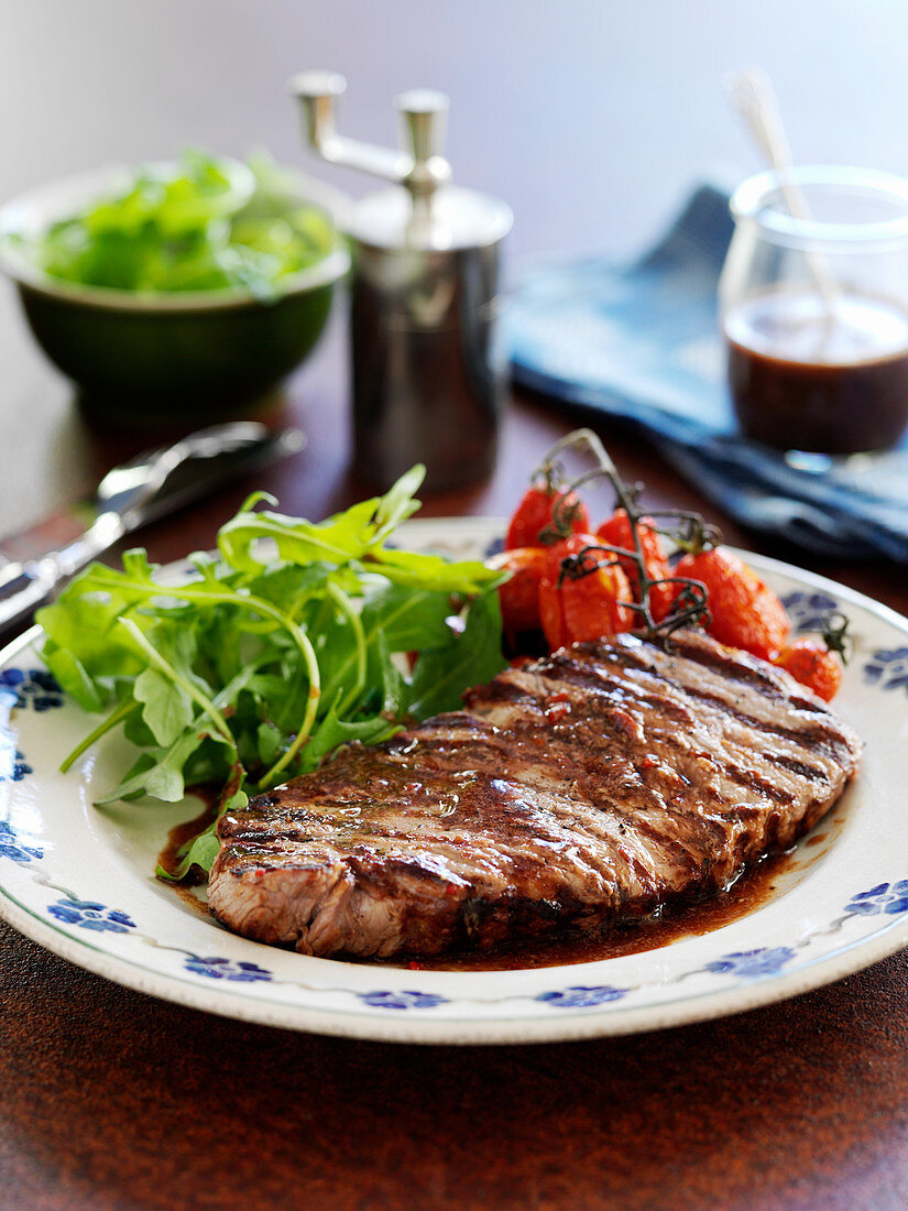 Tagliata with roasted tomatoes and rocket salad