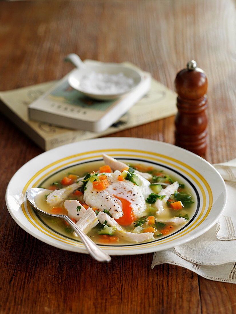 Vegetable soup with chicken and a poached egg