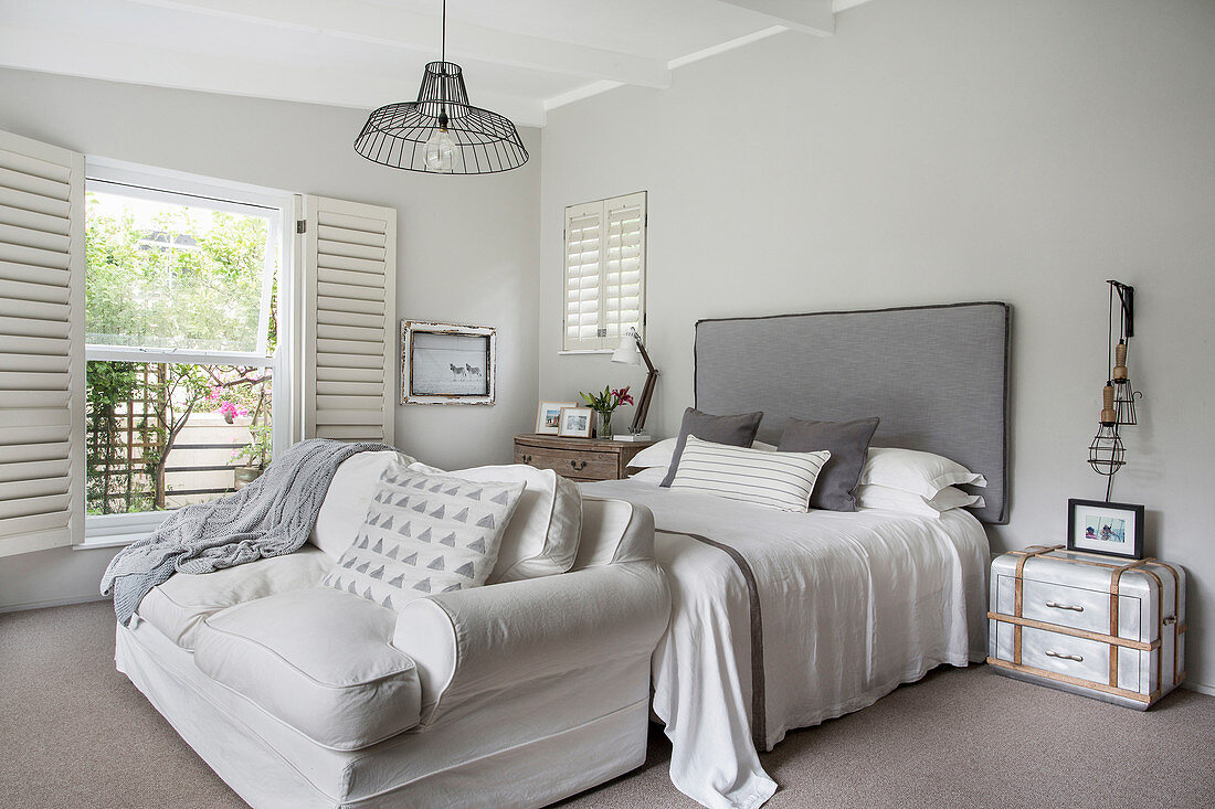 Double bed and sofa in bedroom